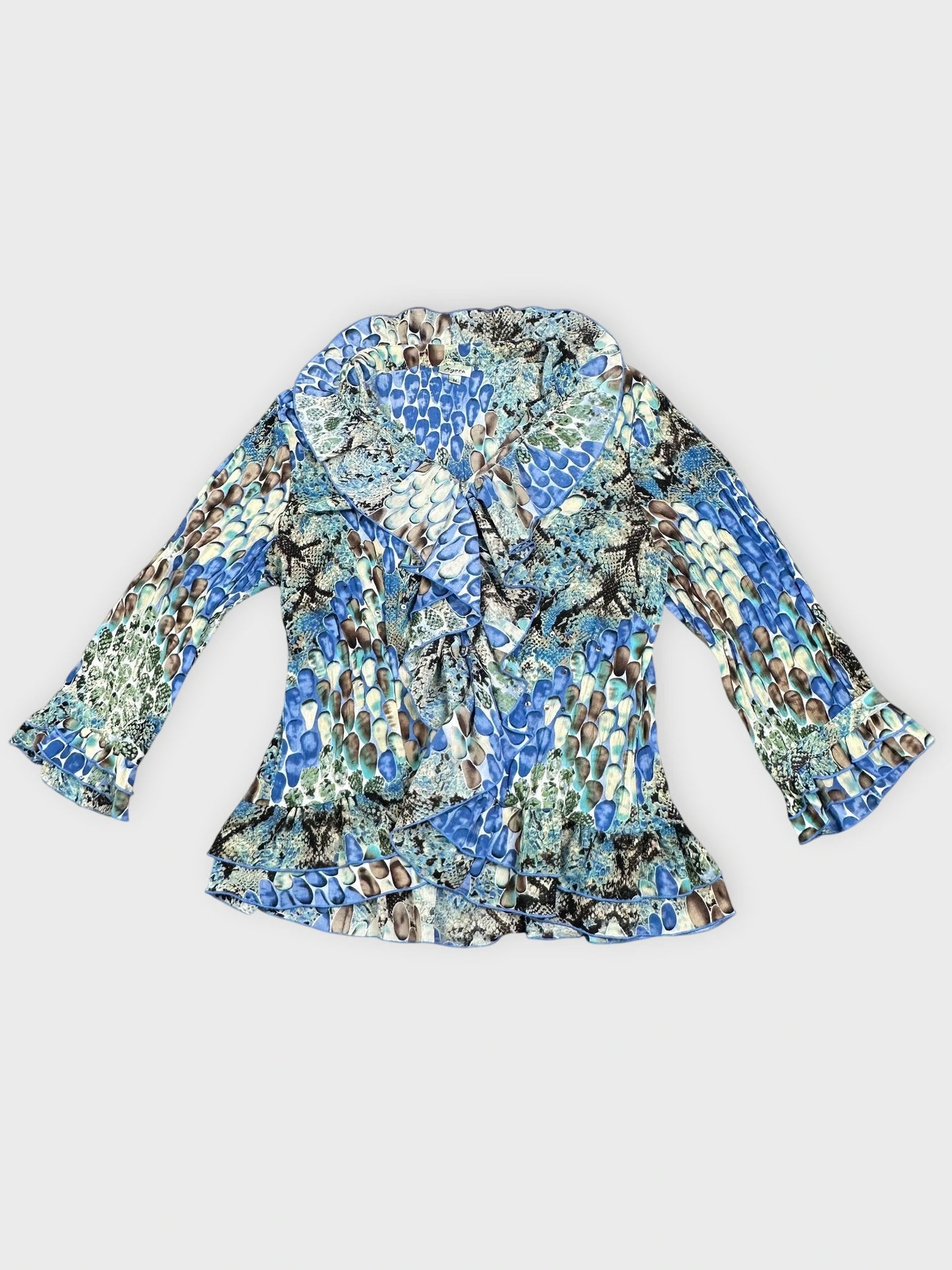 Detail view of a blue patterned vintage top with flared sleeves.