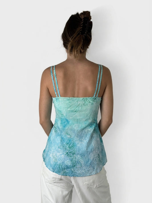 Back view of a lace tie-front top in aqua with floral patterns.