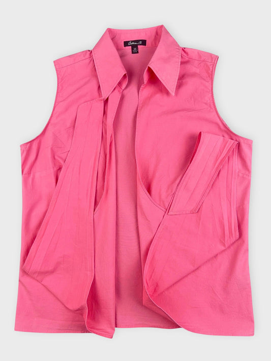 Front view of a pink sleeveless button-down shirt with pleated details.