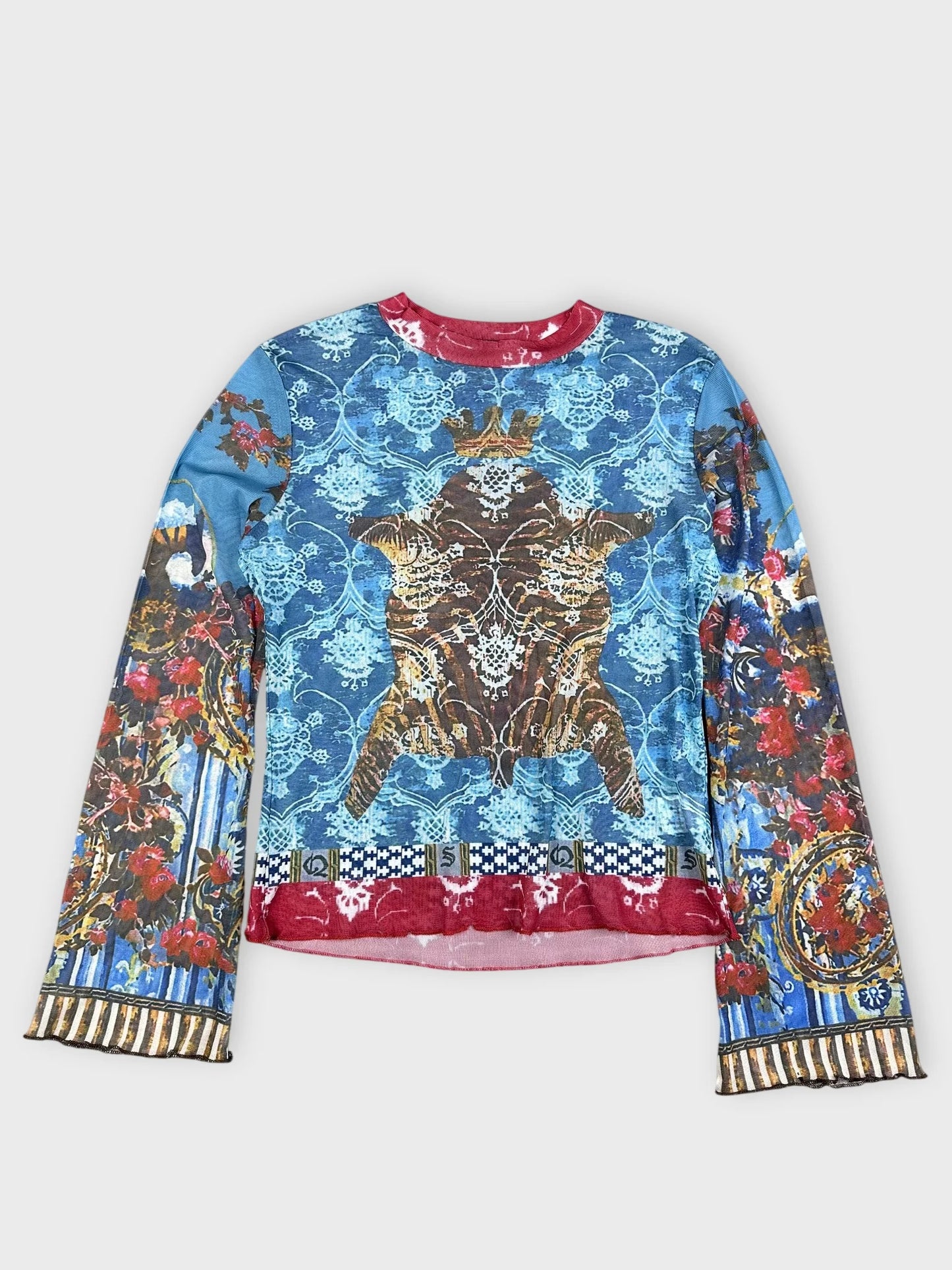 Front view of a long-sleeved mesh top in blue with a baroque print.