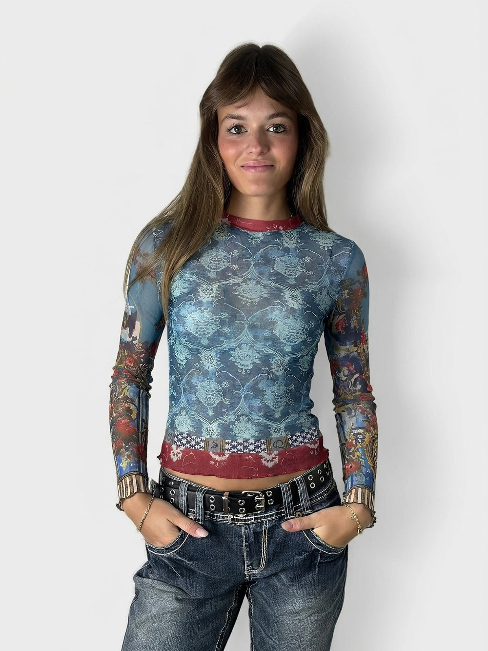Front view of a blue mesh long-sleeve top featuring a floral pattern.