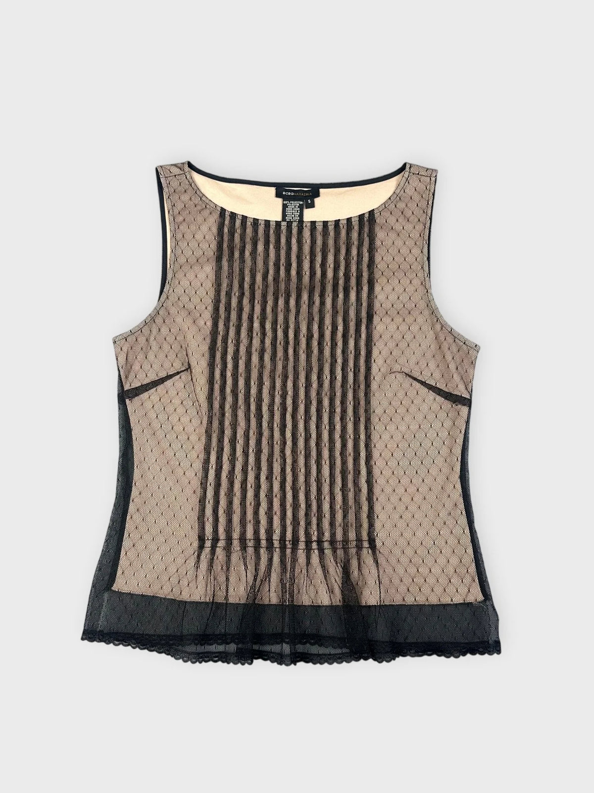 Front view of a beige mesh top with pleats and black trim.
