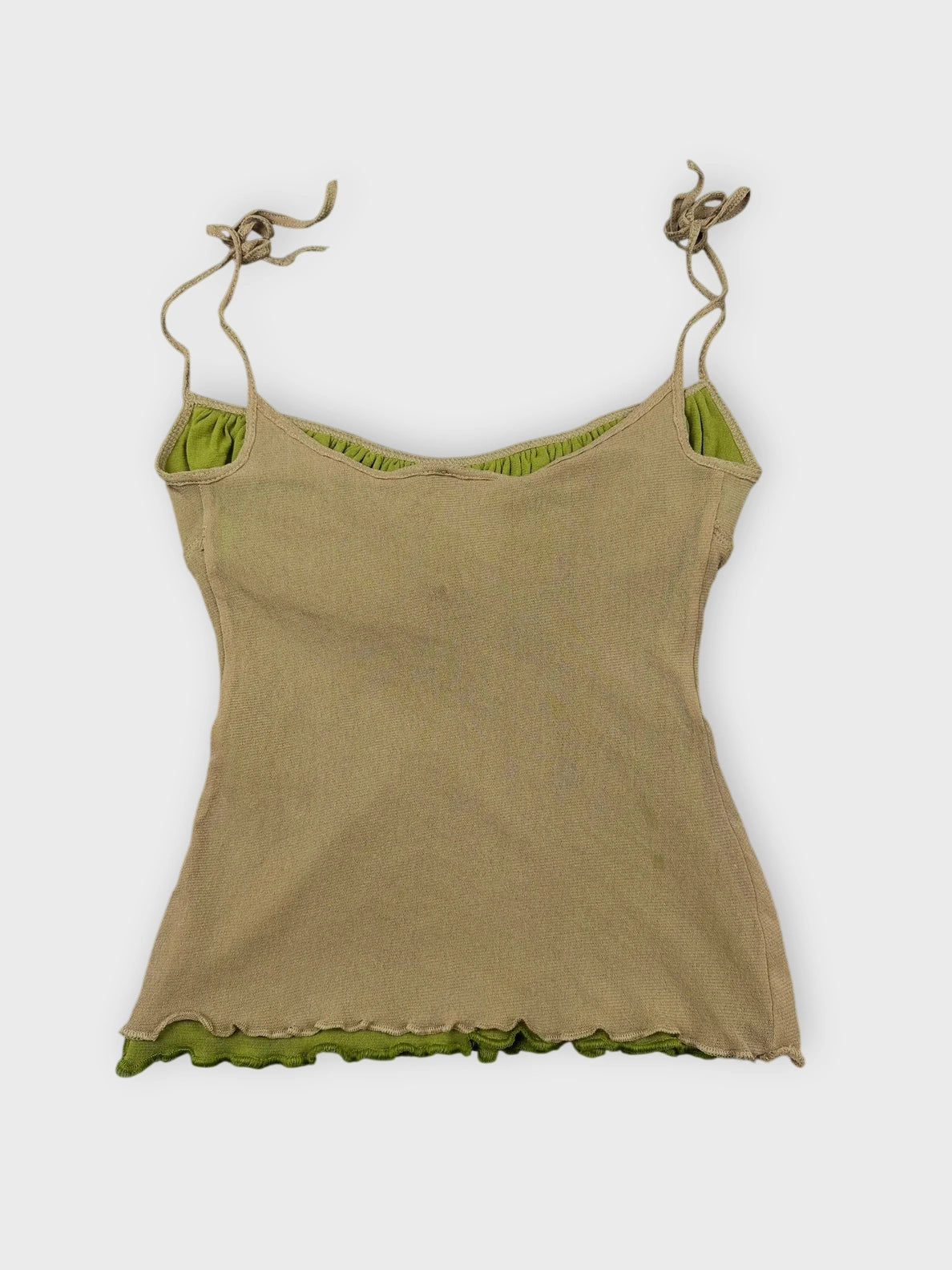 Beige ruffled crop top with green trim back view showing playful edges.