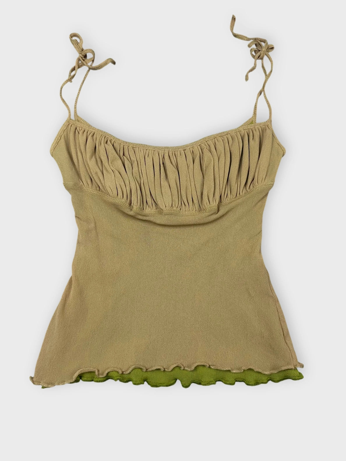 Beige ruffled crop top with playful edges front view