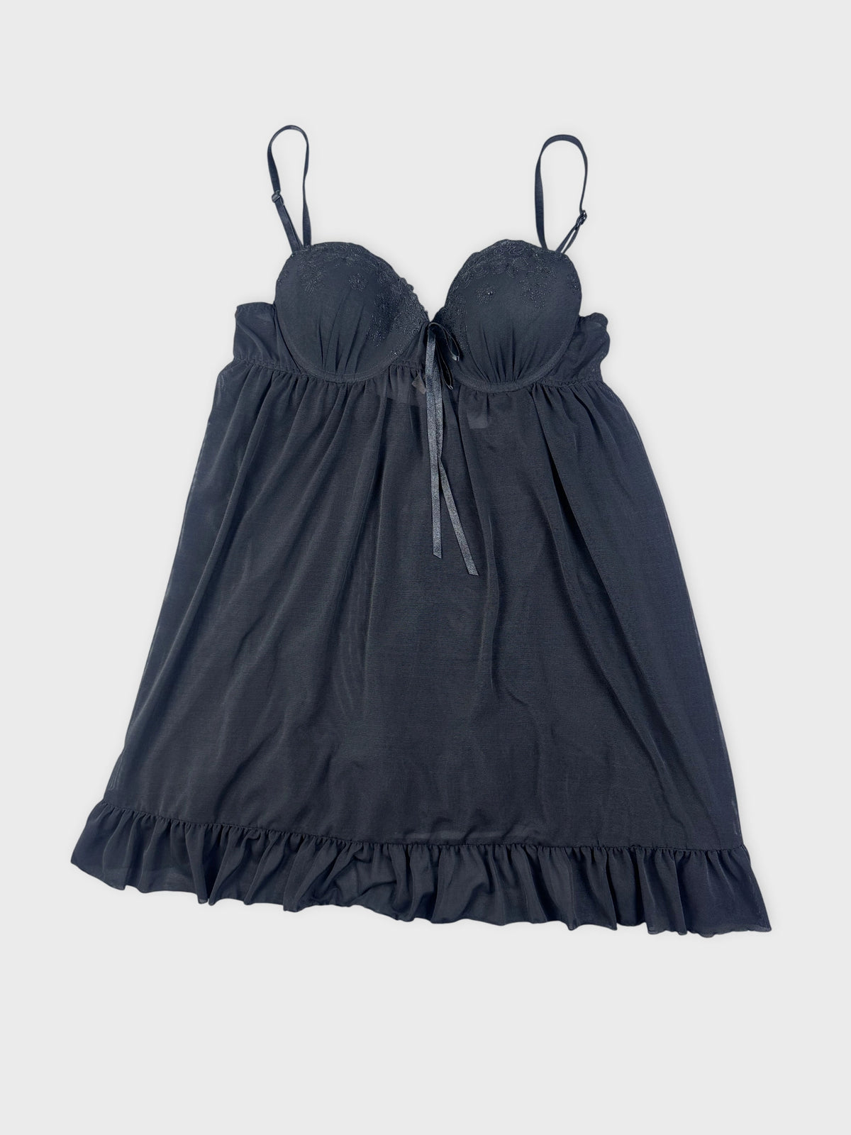 Black camisole with lace trim and flared shape detail view.