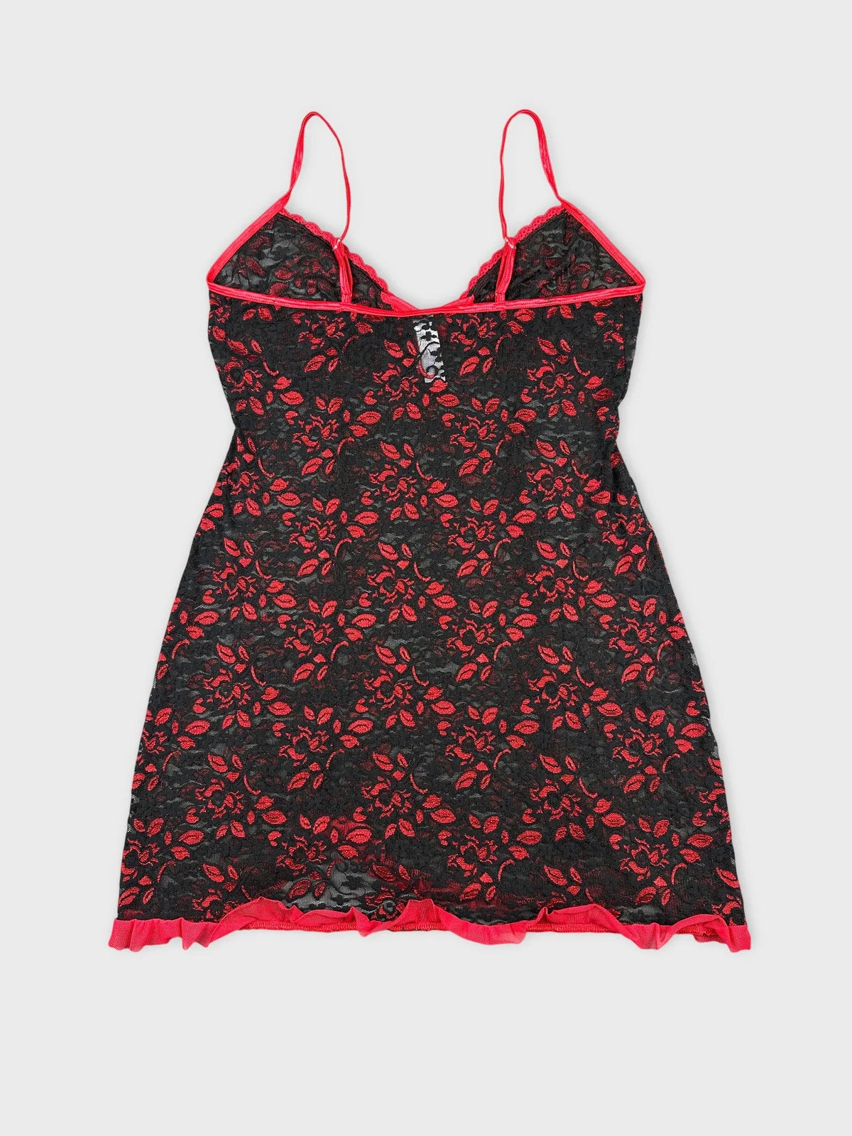 Back view of black floral lace top with red trim and adjustable straps.