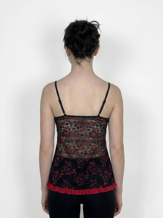 Back view of black lace camisole with red trim and floral pattern.