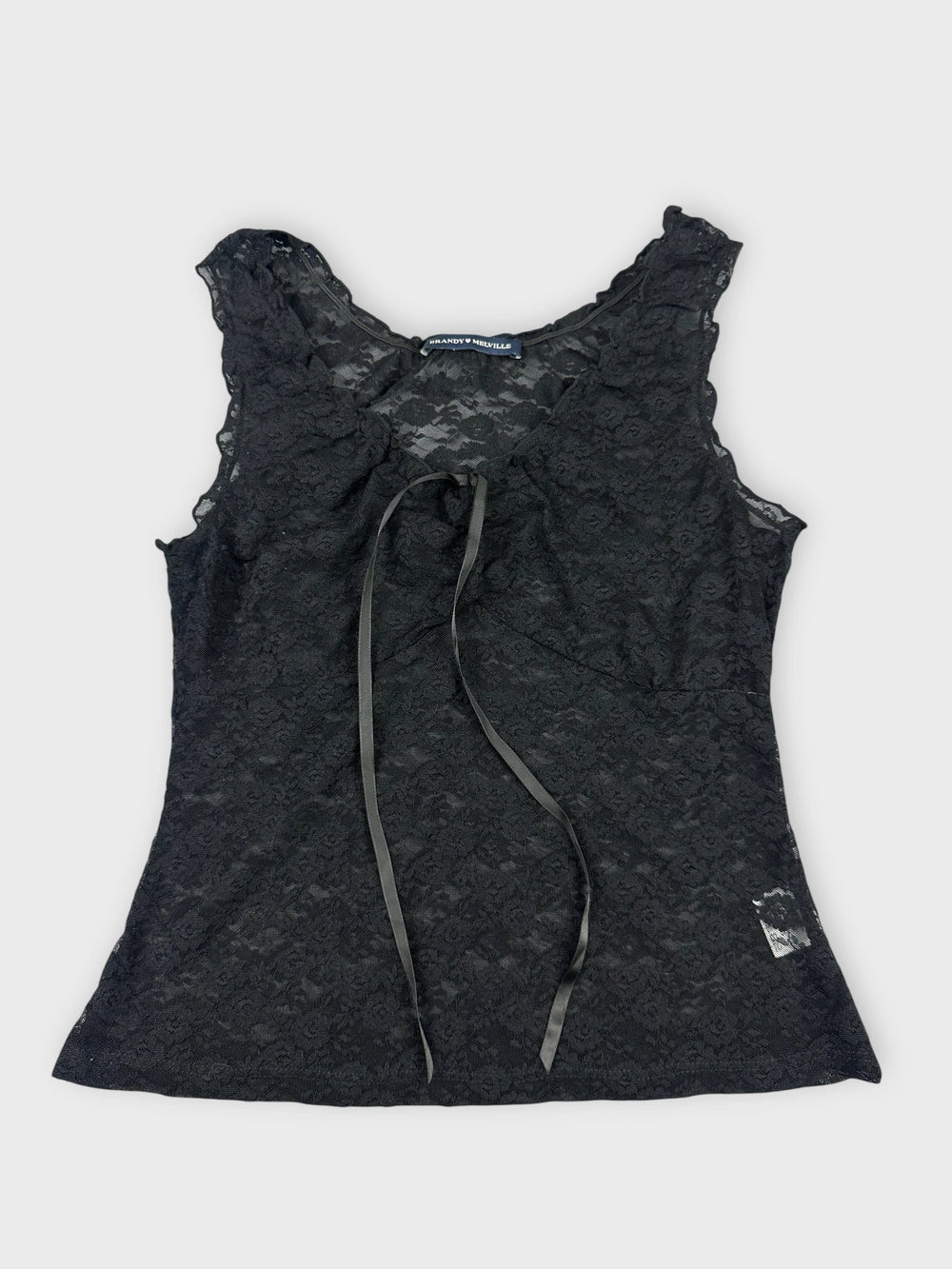Black lace top with floral details front view featuring a tie and delicate pattern.