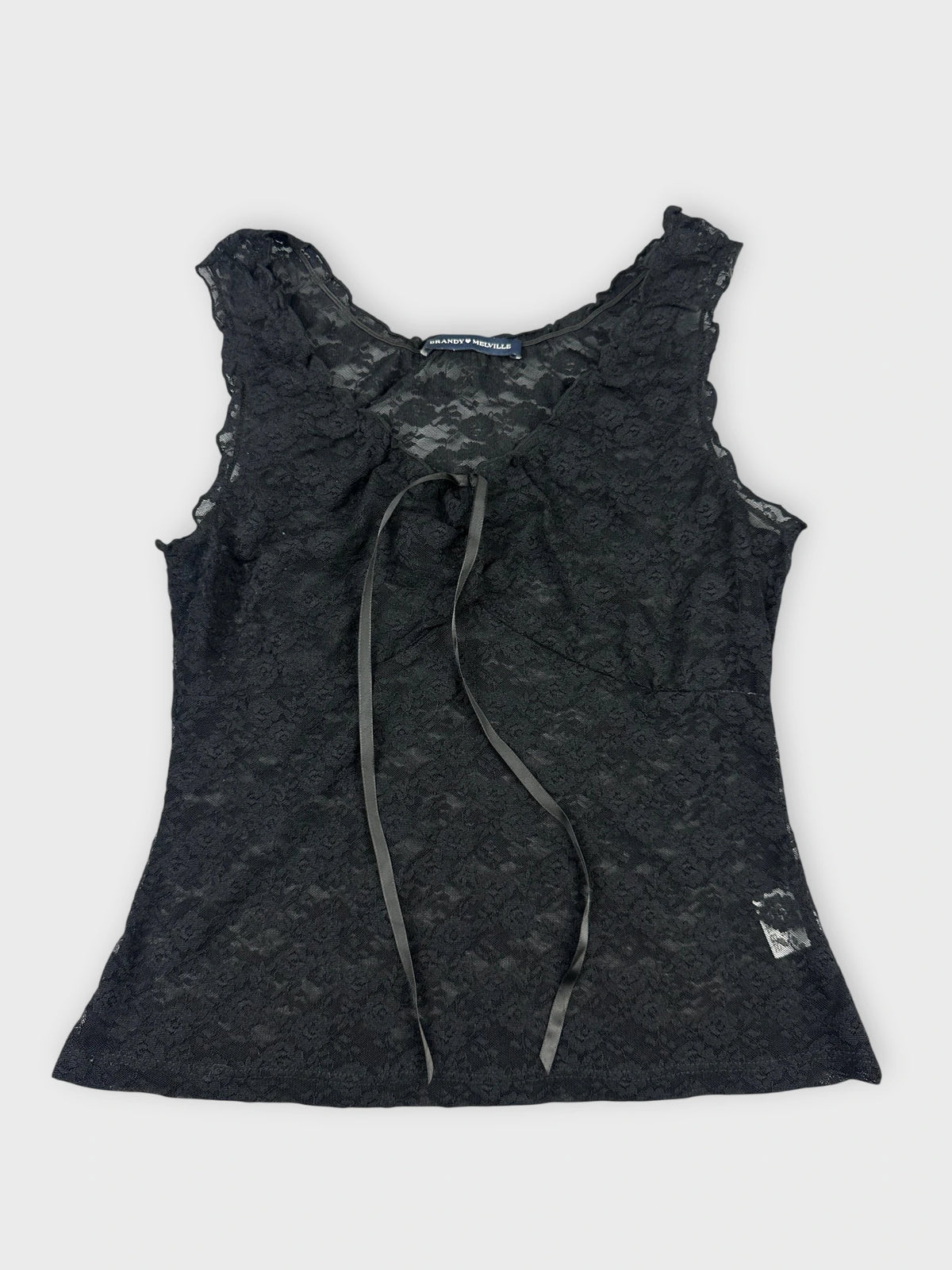 Black lace top with floral details front view featuring a tie and delicate pattern.