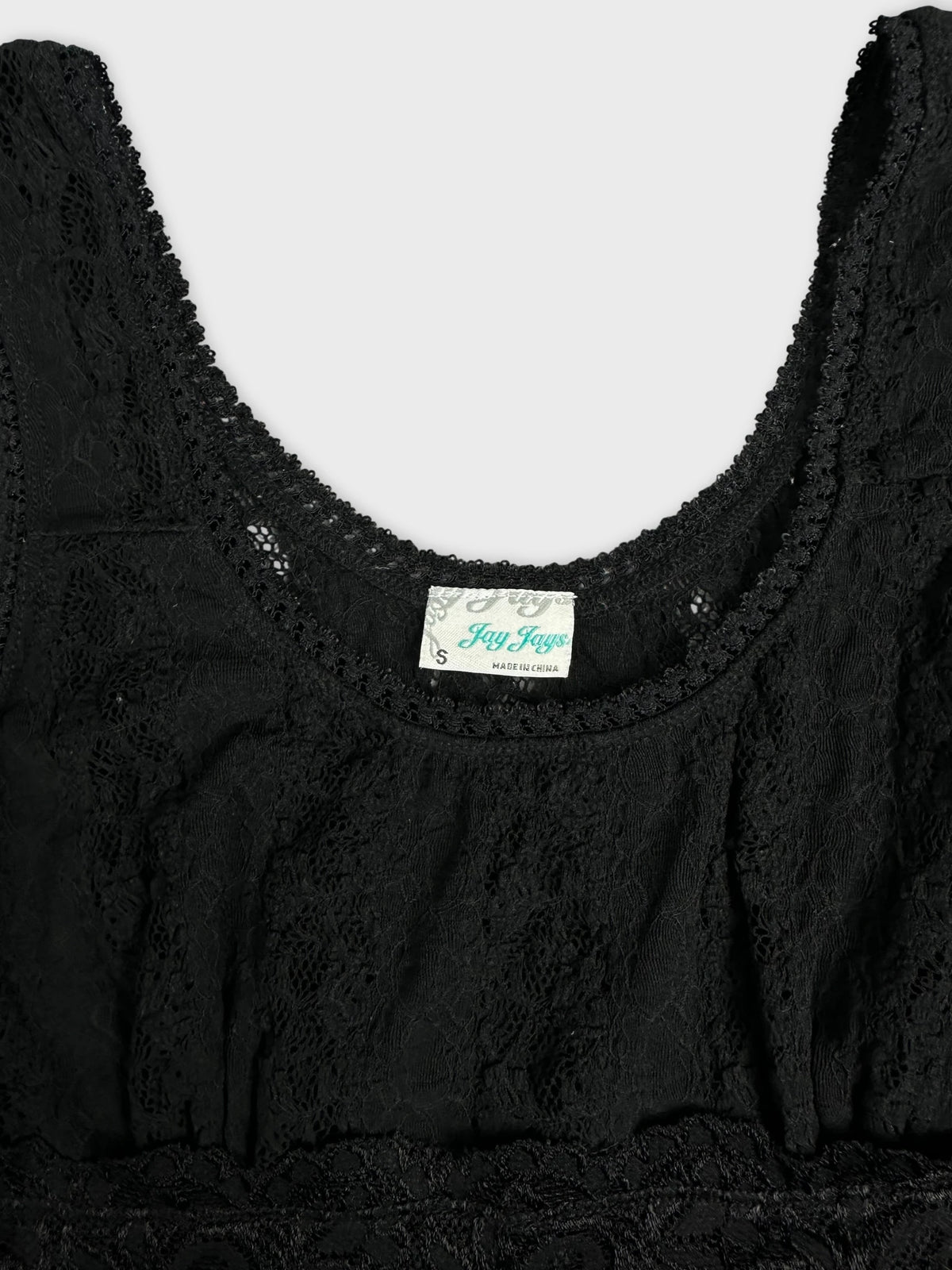 Detail view of a black lace top with intricate lace trim.
