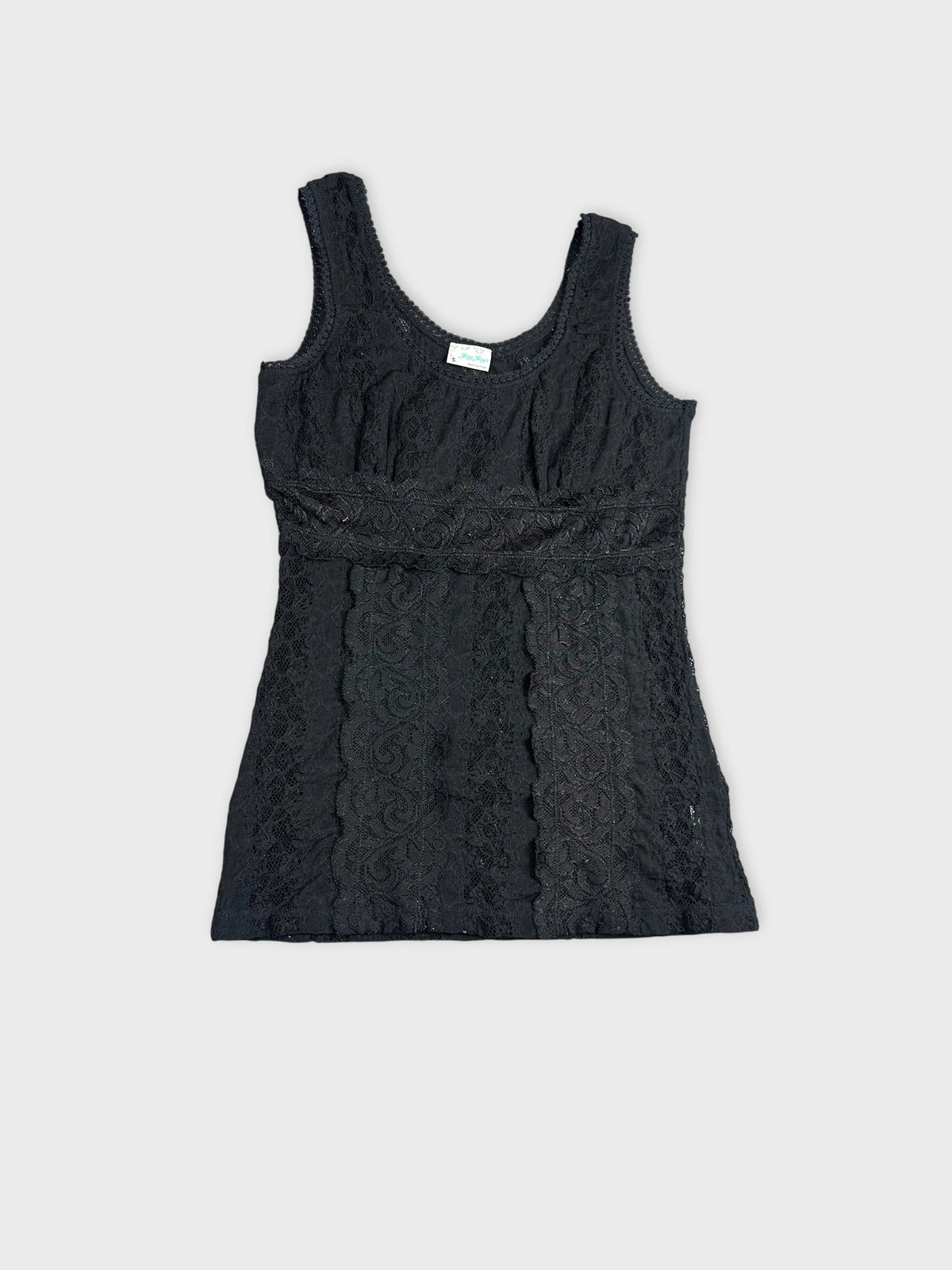 Detail view of a black lace top featuring intricate patterns.
