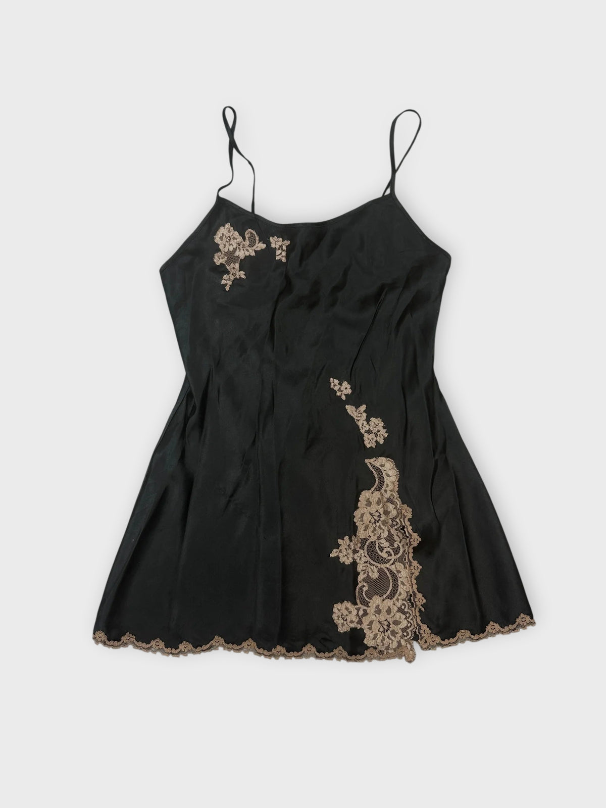 Front view of a black cami top with lace trim and floral details.