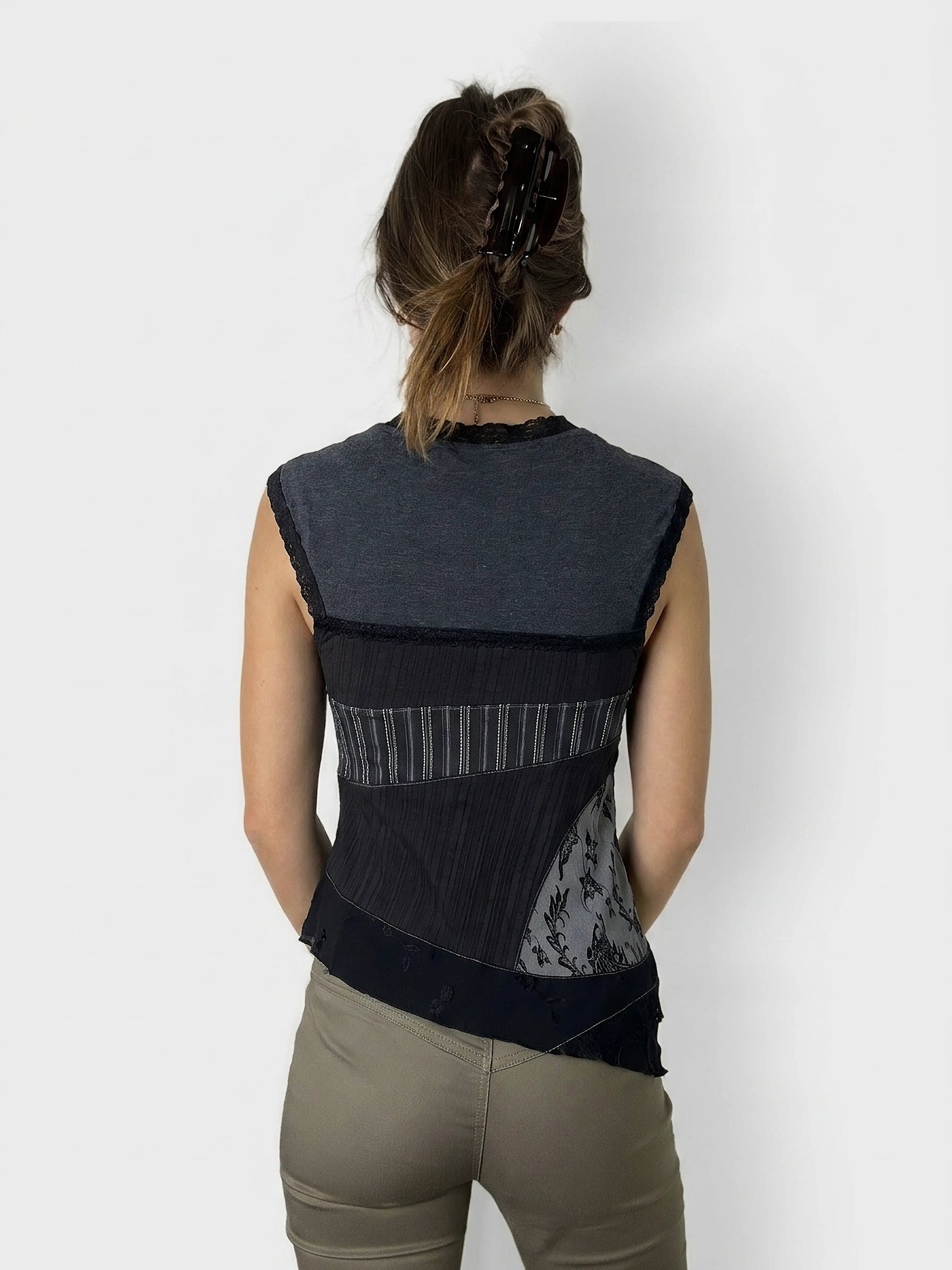 Back view of a black layered tank top showcasing lace details.
