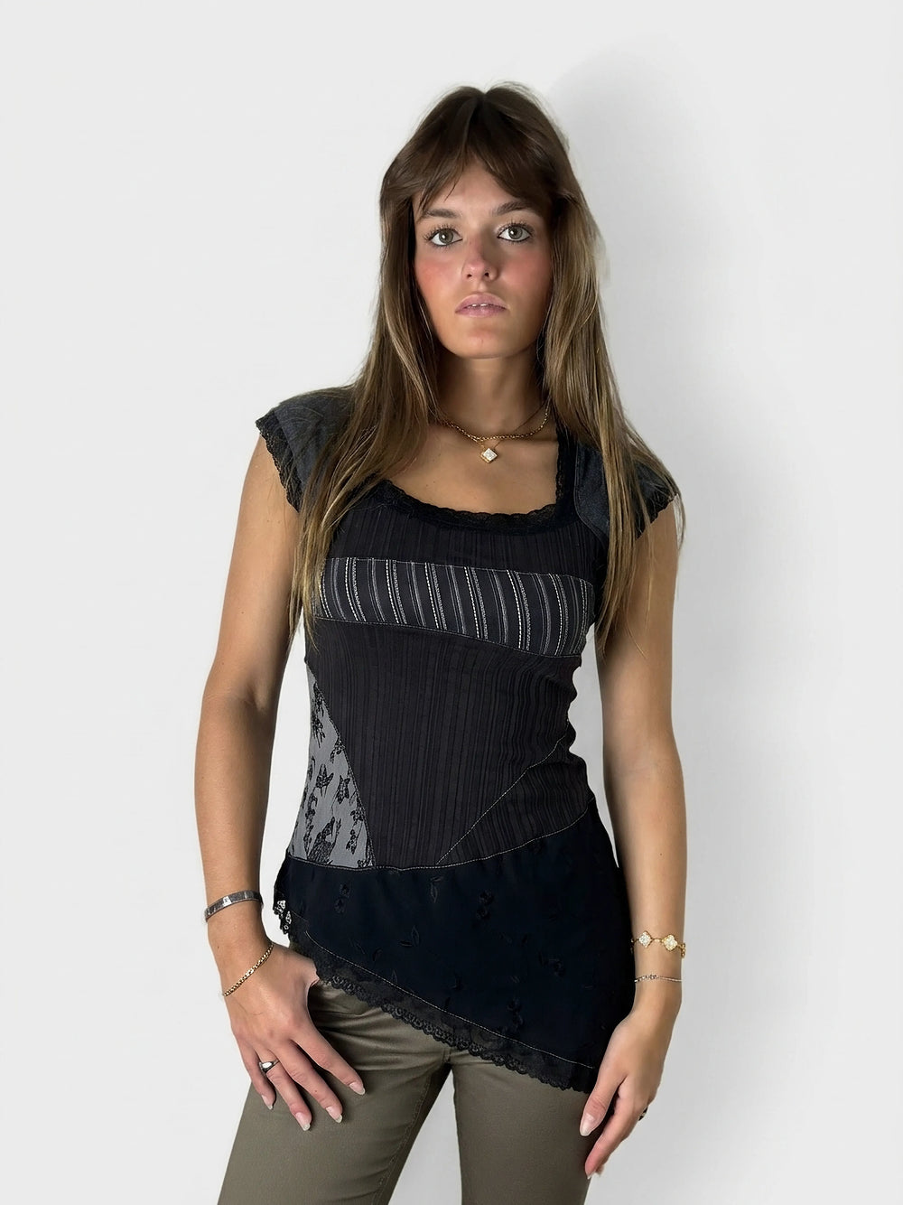 Front view of a black layered tank top with lace details.