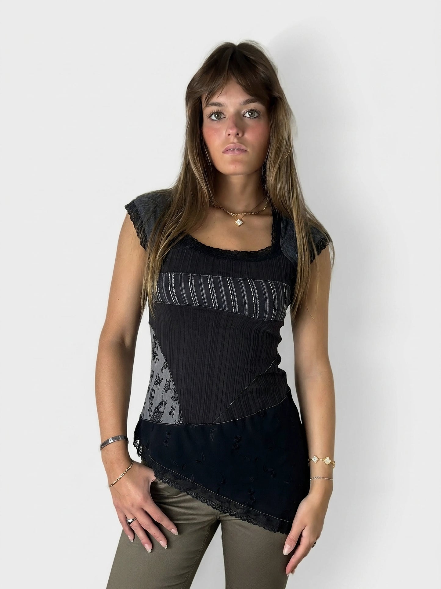Front view of a black layered tank top with lace details.