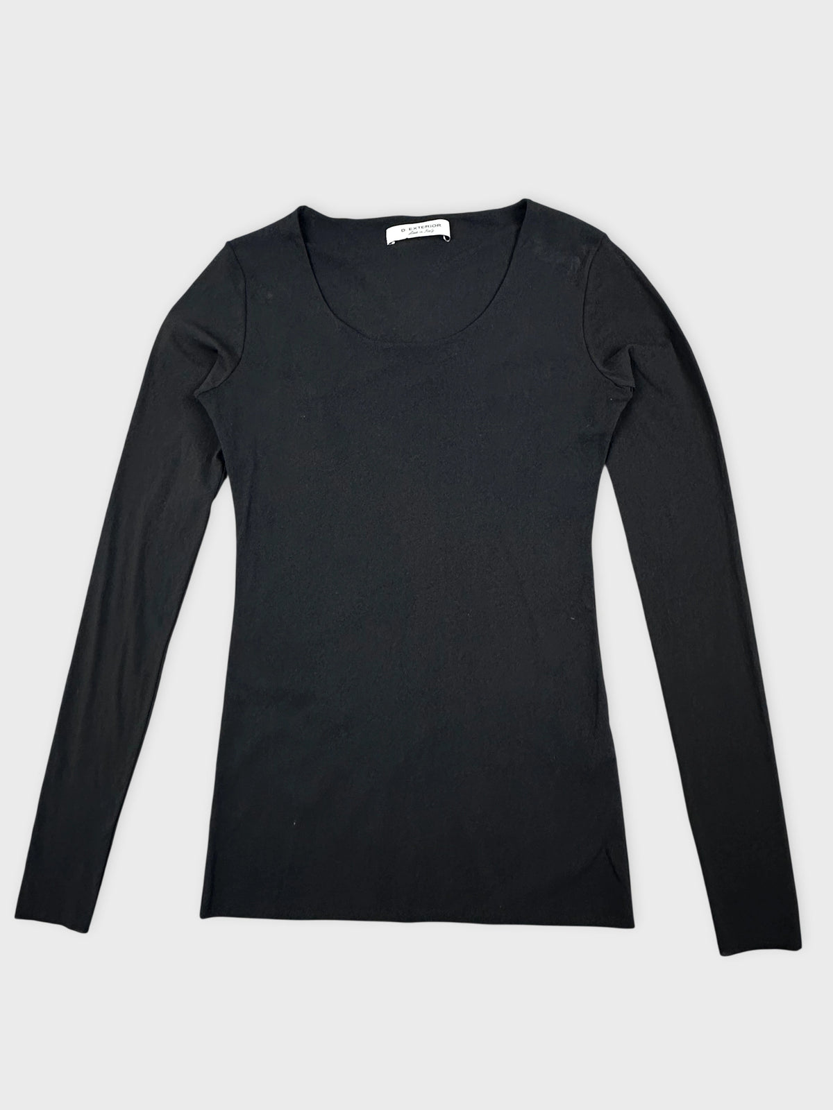 Black long sleeve knit dress detail view showing a smooth texture and round neckline.