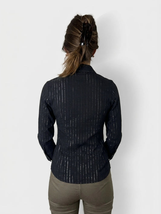 Back view of a fitted black pinstripe shirt with subtle shine details.