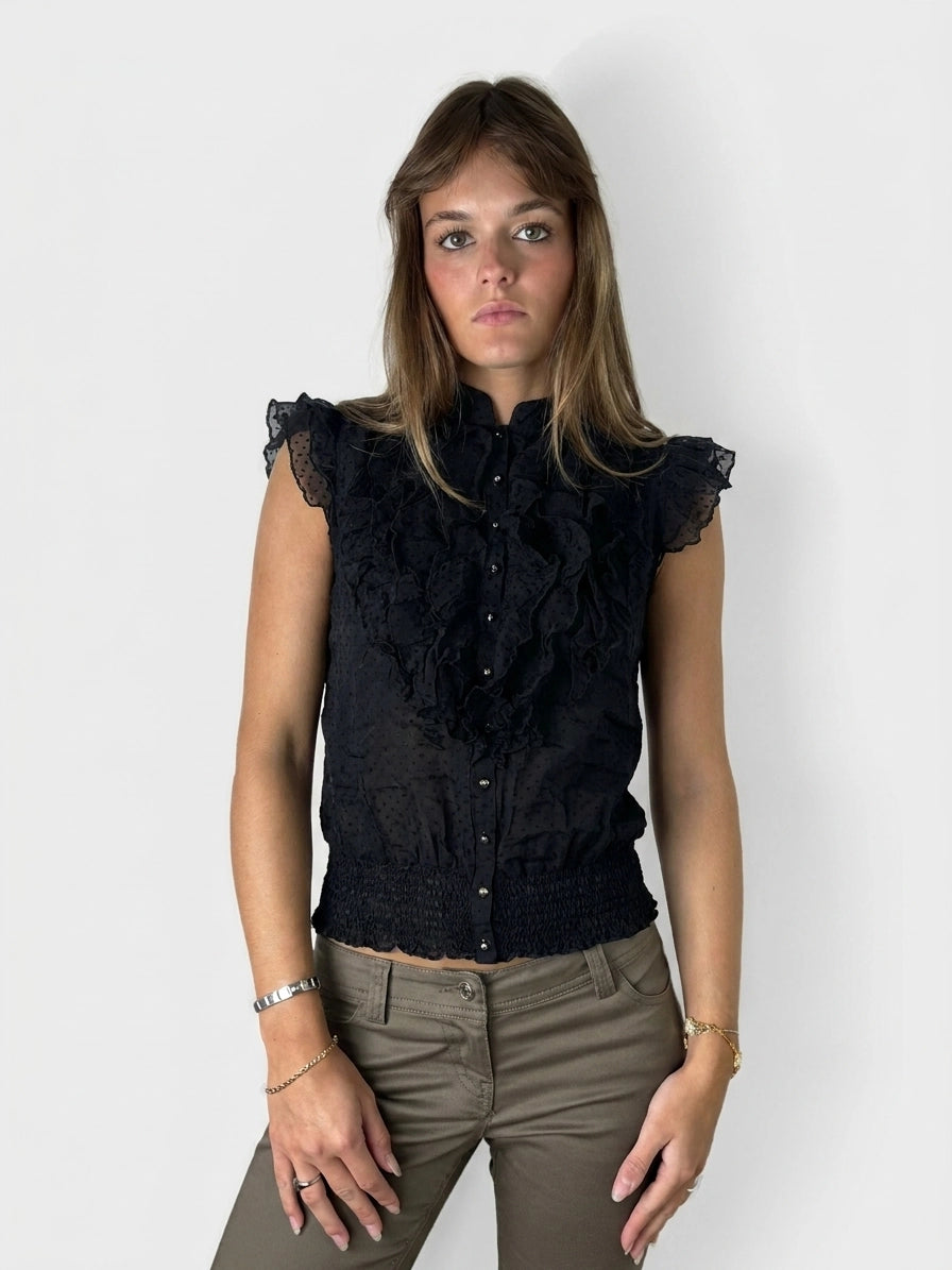 Front view of a black ruffled blouse featuring button details.