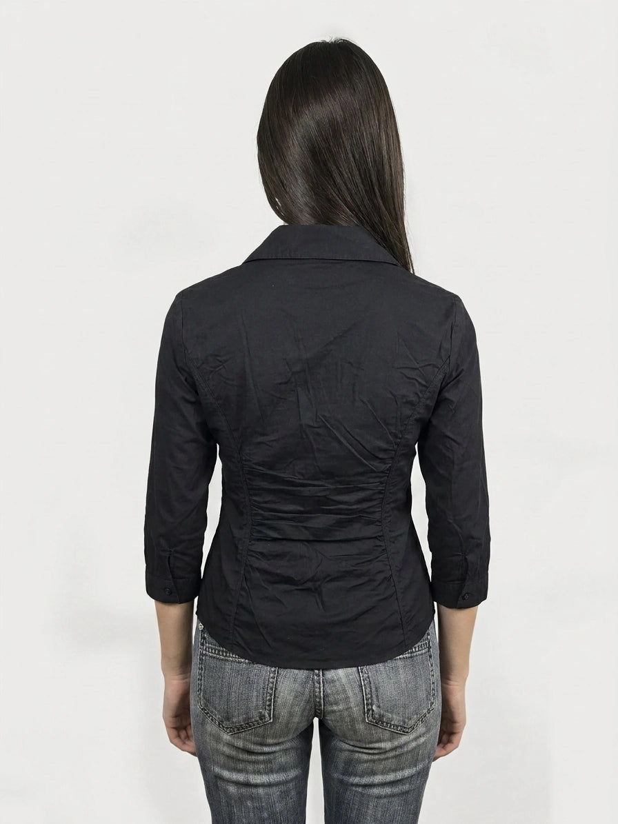 Back view of a black short sleeve shirt with ruching detail.