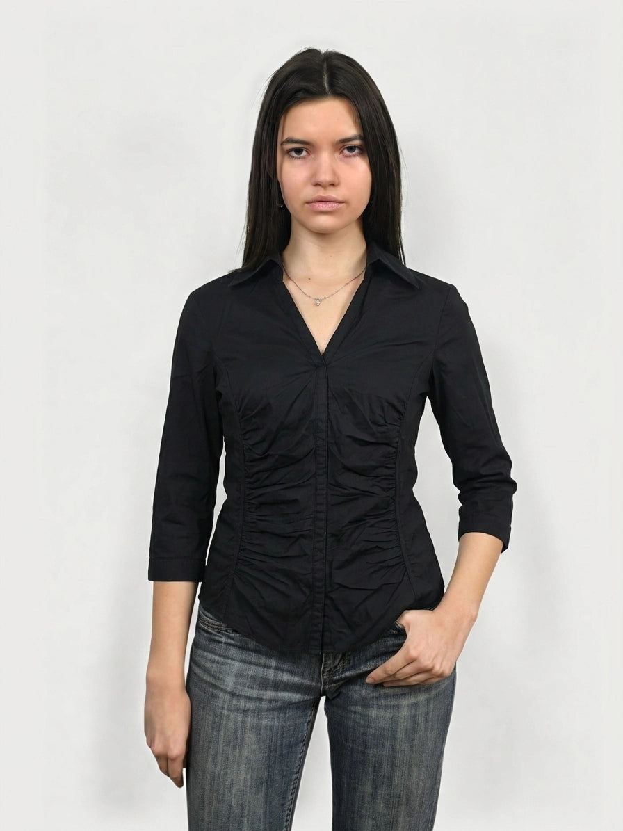 Front view of a black short sleeve shirt with ruching detail.