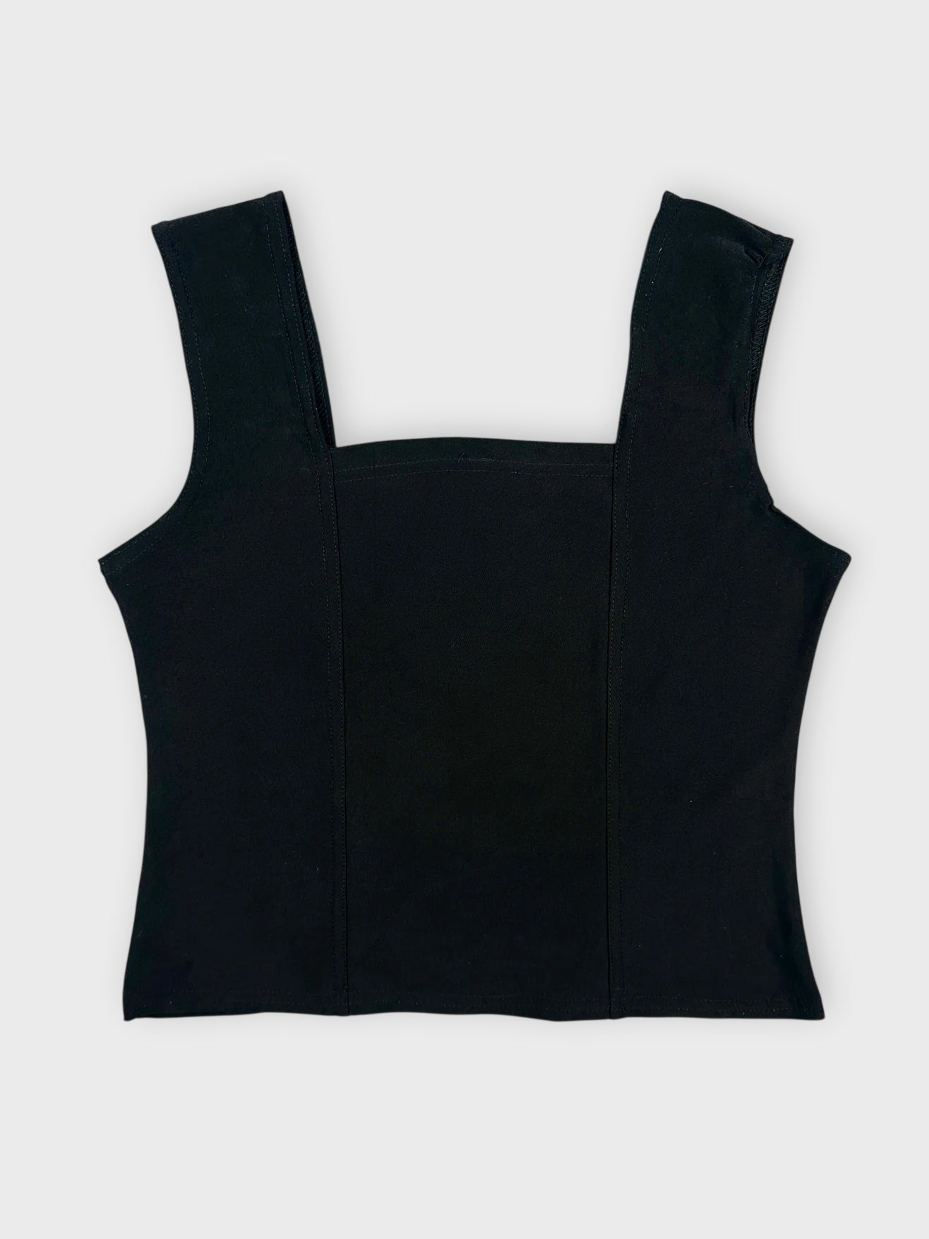 Back view of a black sleeveless top with a square neck and structured design.