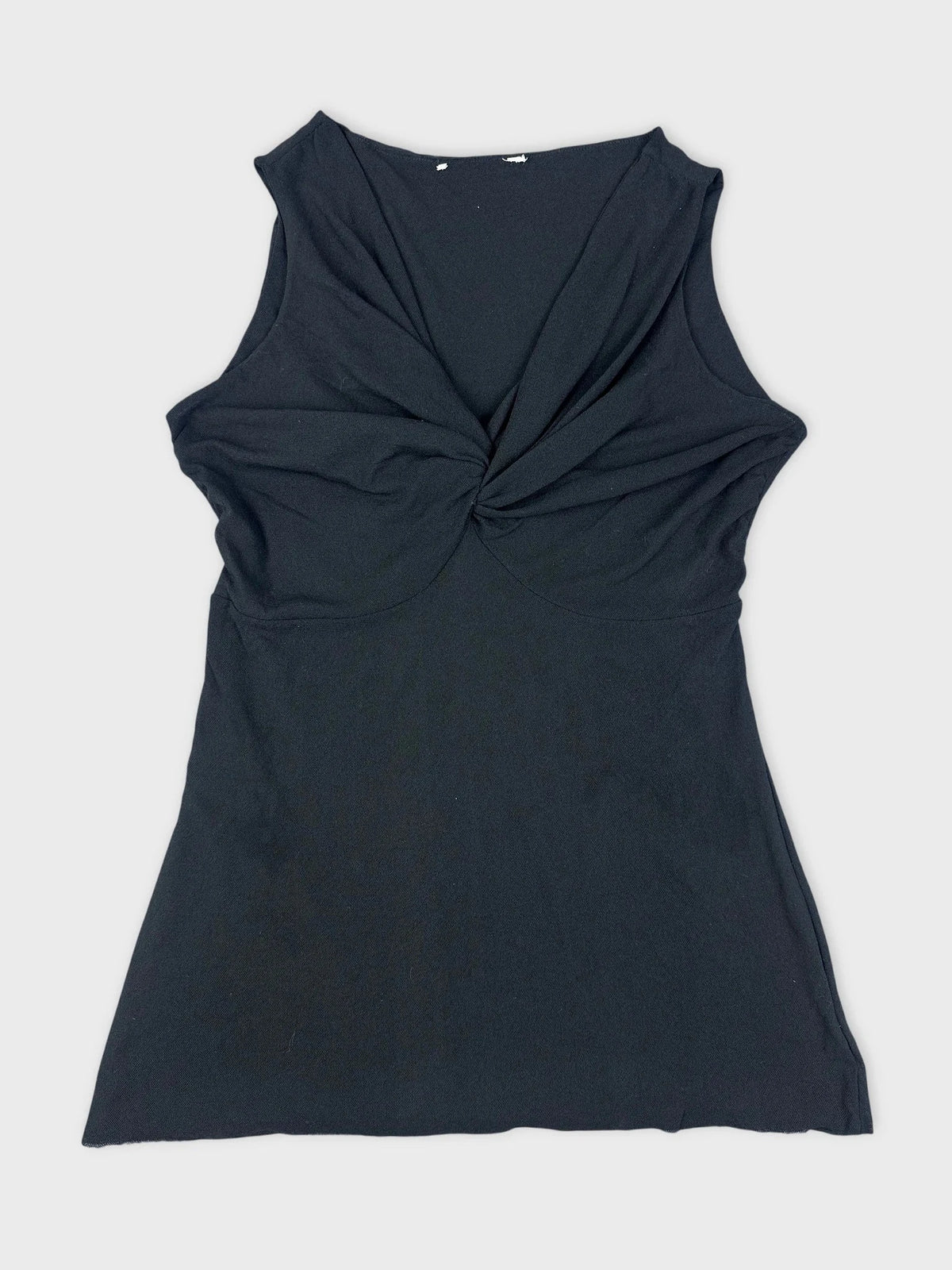 Black sleeveless top with twist detail front view.