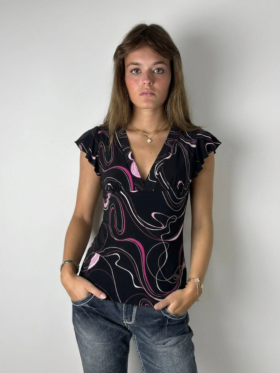 Front view of a black swirl print top with ruffled sleeves.