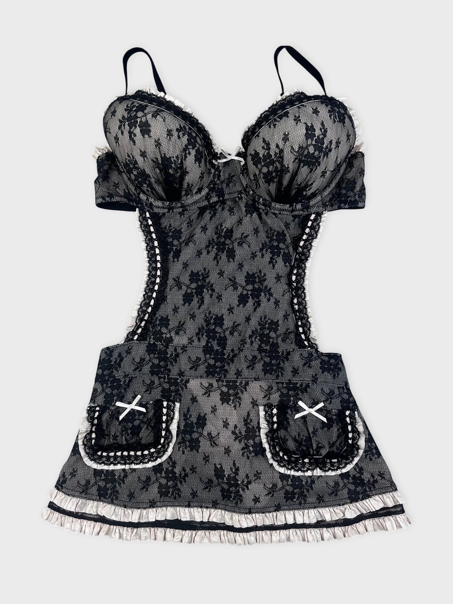 Front view of a black lace top with ruffled straps and pocket detail.