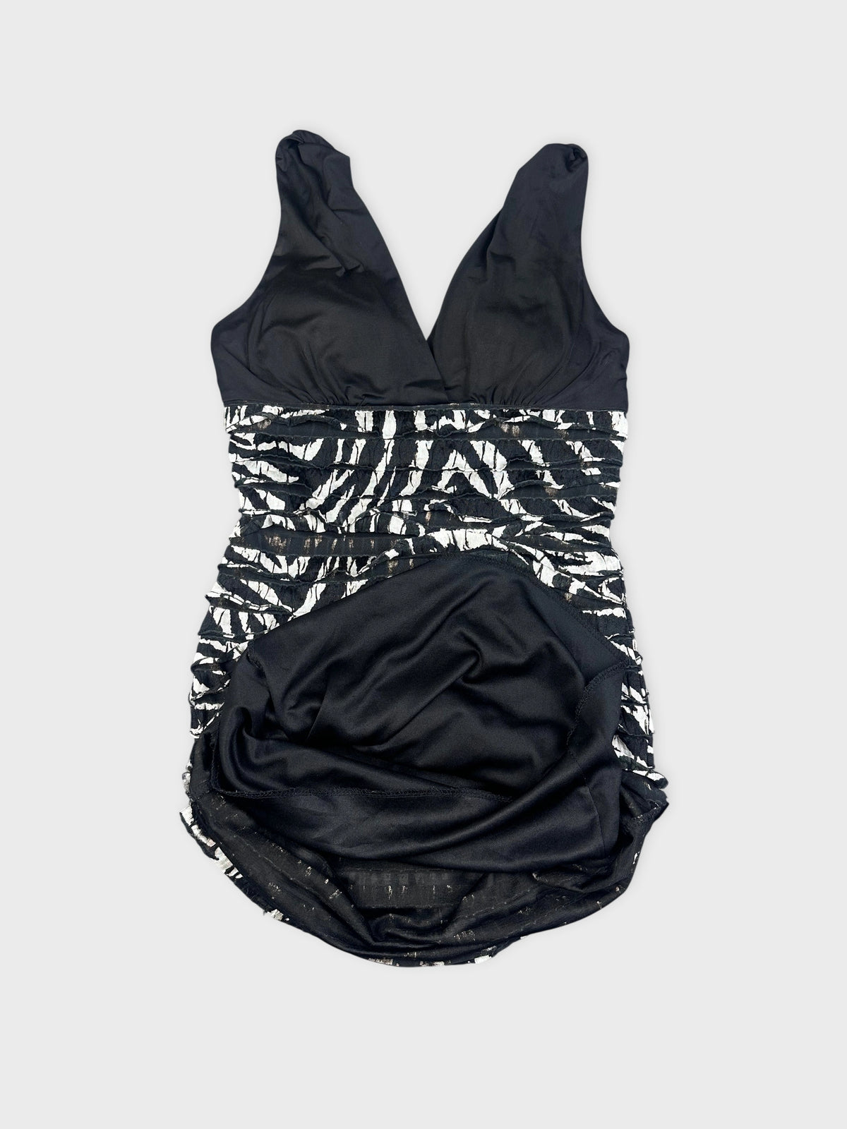 Detail view of a black and white zebra striped mini dress.