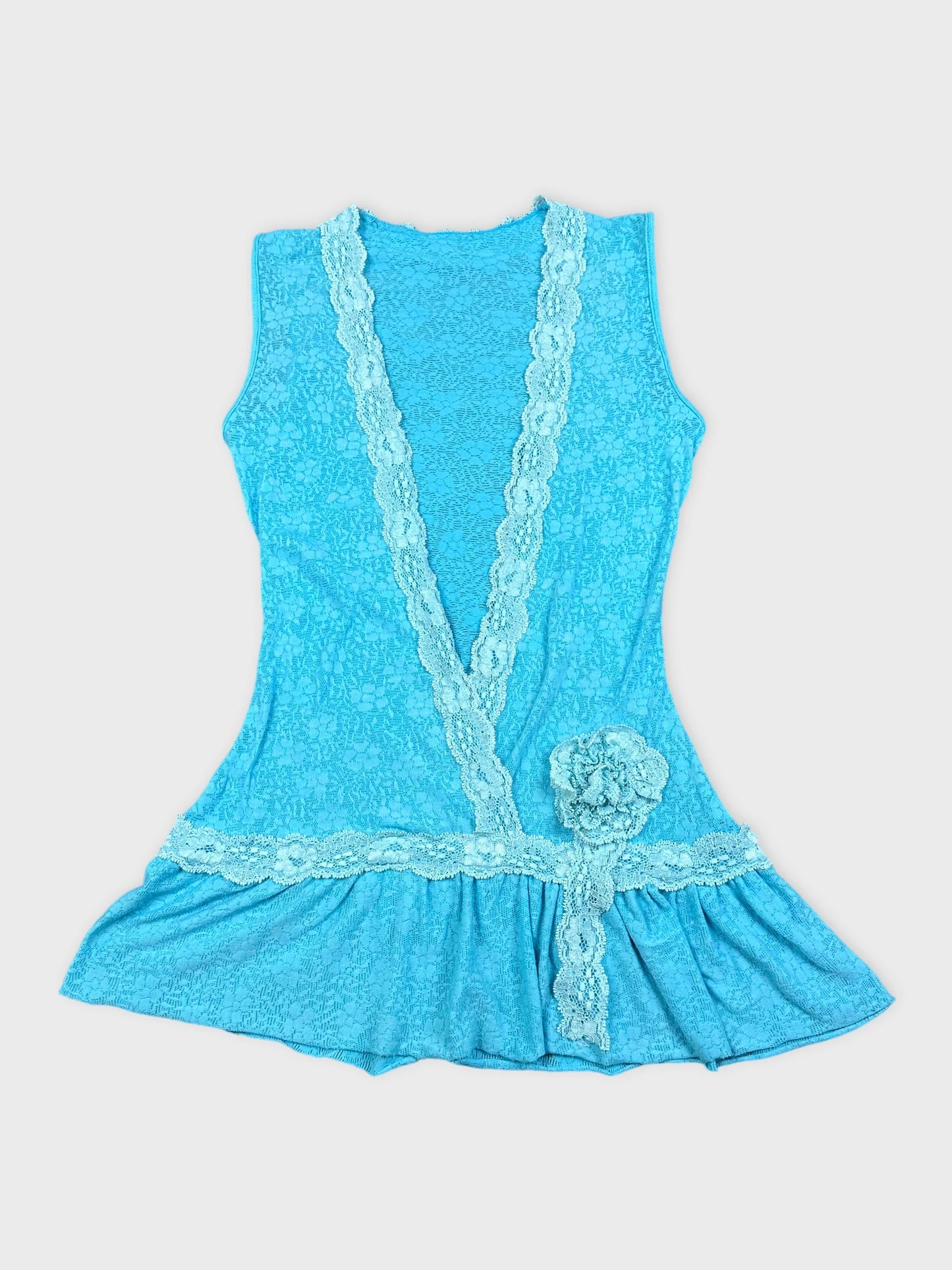 Blue top with lace trim and flower detail front view