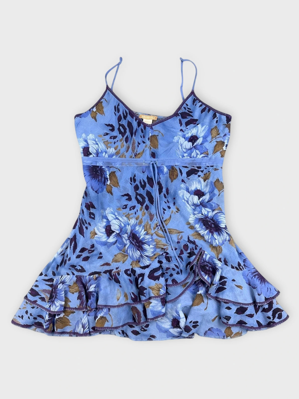Detail view of bold floral ruffle dress in blue with layered ruffle hem