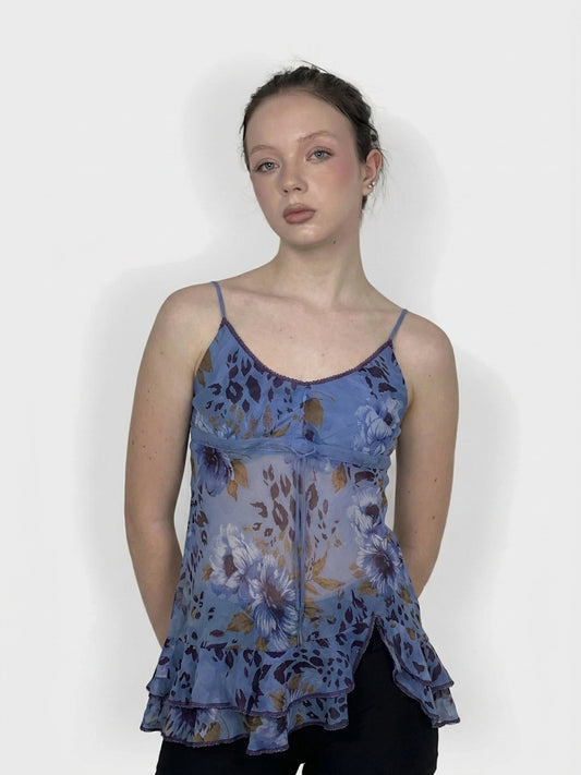 Front view of a blue floral ruffle dress with a sheer fabric and detailed trim.