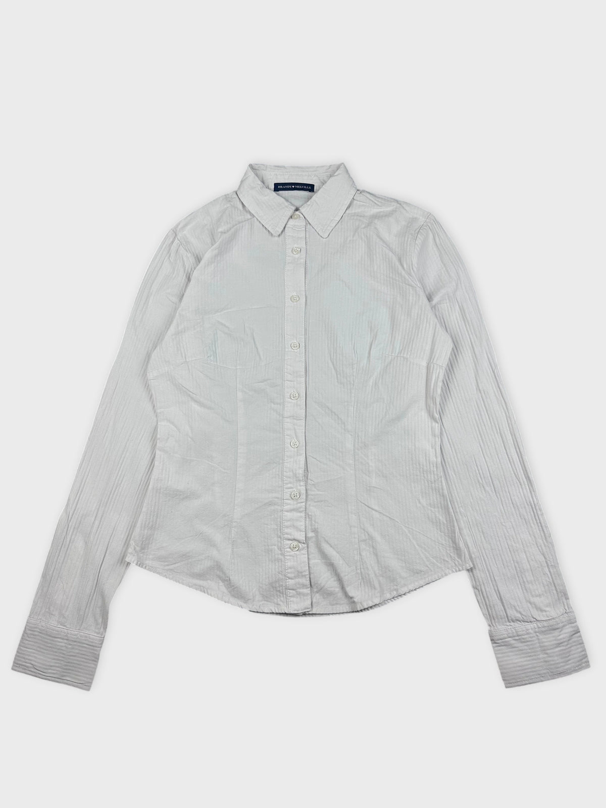Detail view of a white striped button-down shirt with a collared neckline.