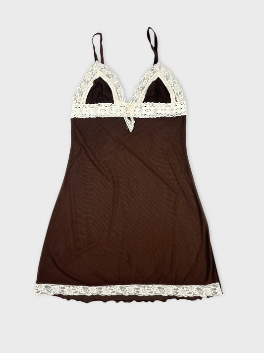 Front view of brown mesh crop top with lace detail and adjustable straps