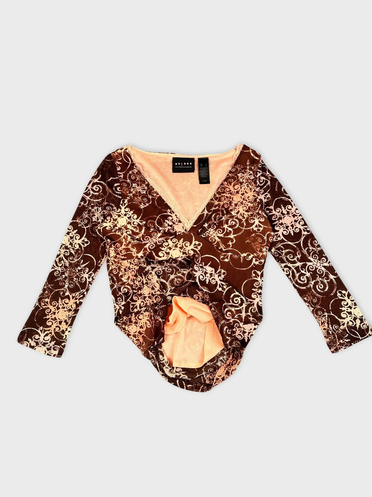 Detail view of brown sheer long sleeve top with floral print.