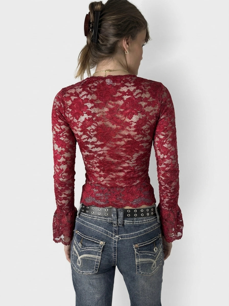 Back view of a burgundy lace blouse with flared sleeves.