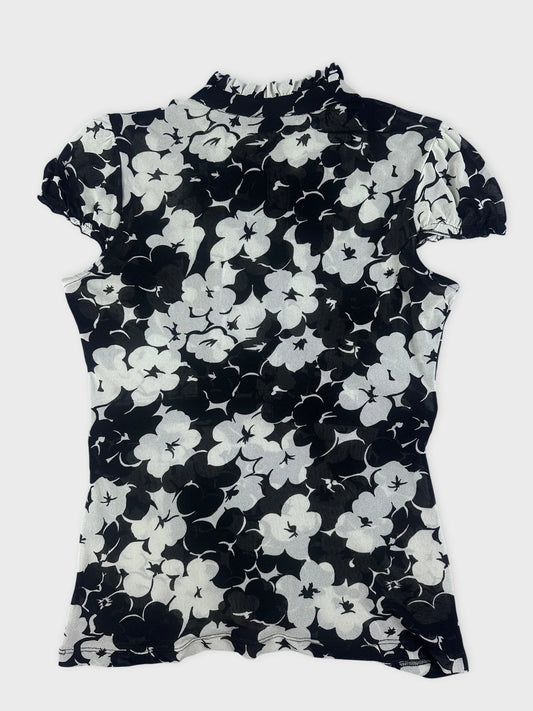 Back view of a black floral playsuit with ruffle detail.