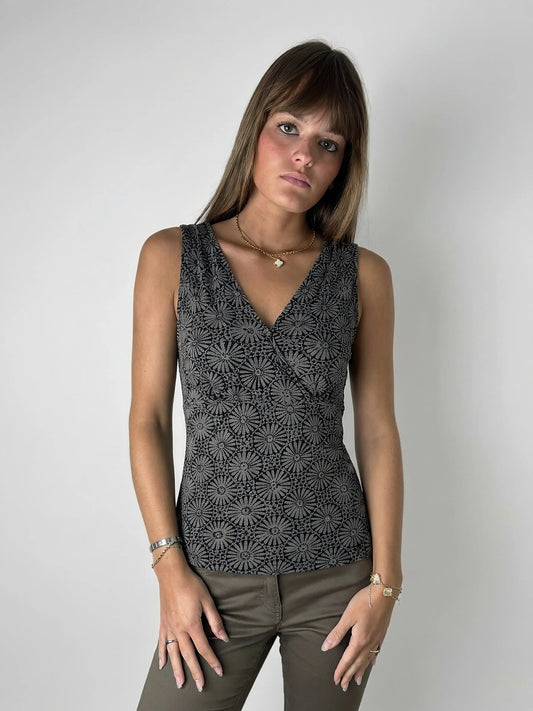 Front view of a black floral print tank top with v-neck design.