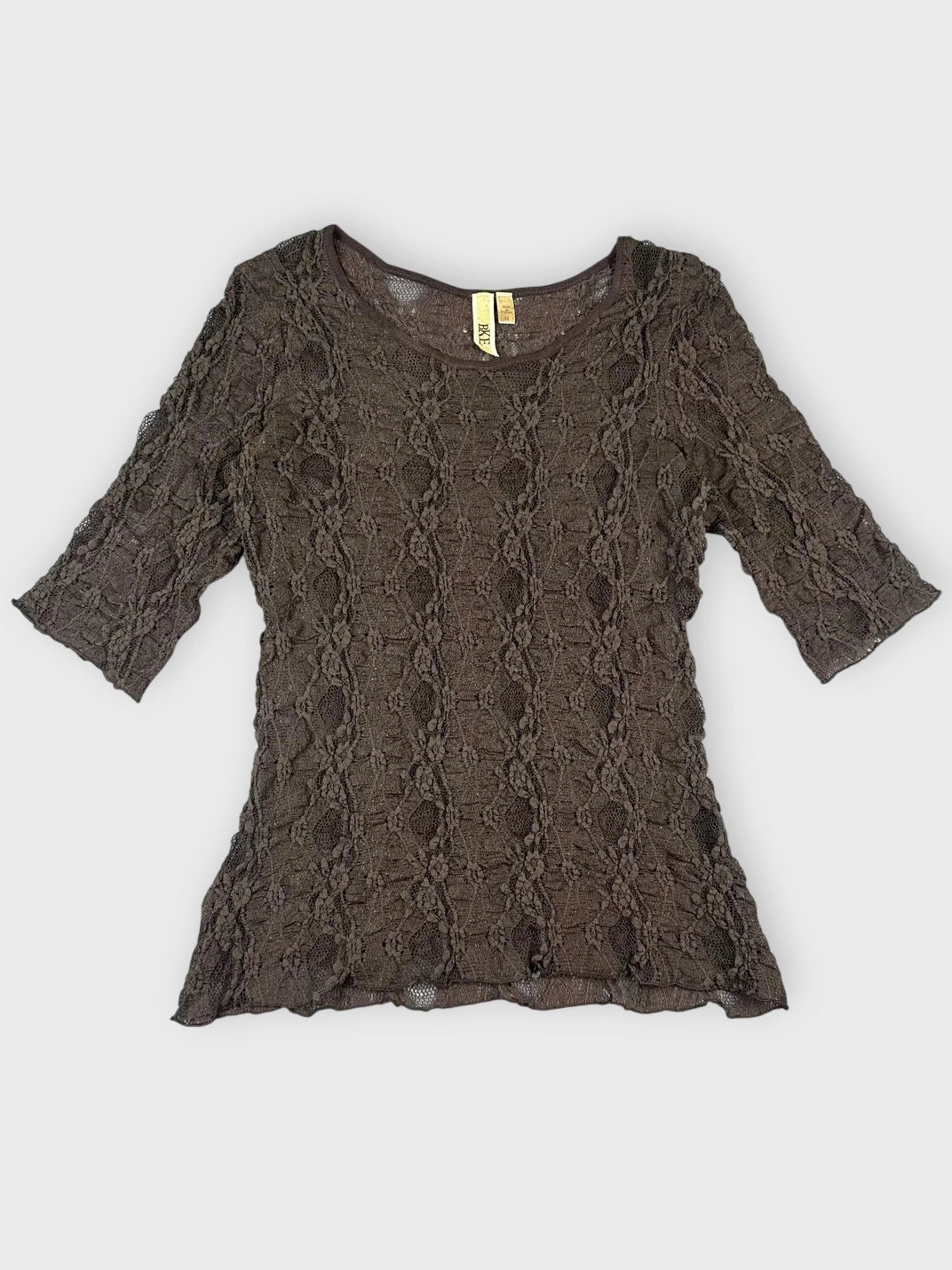 Front view of a black lace top with short sleeves and floral pattern.