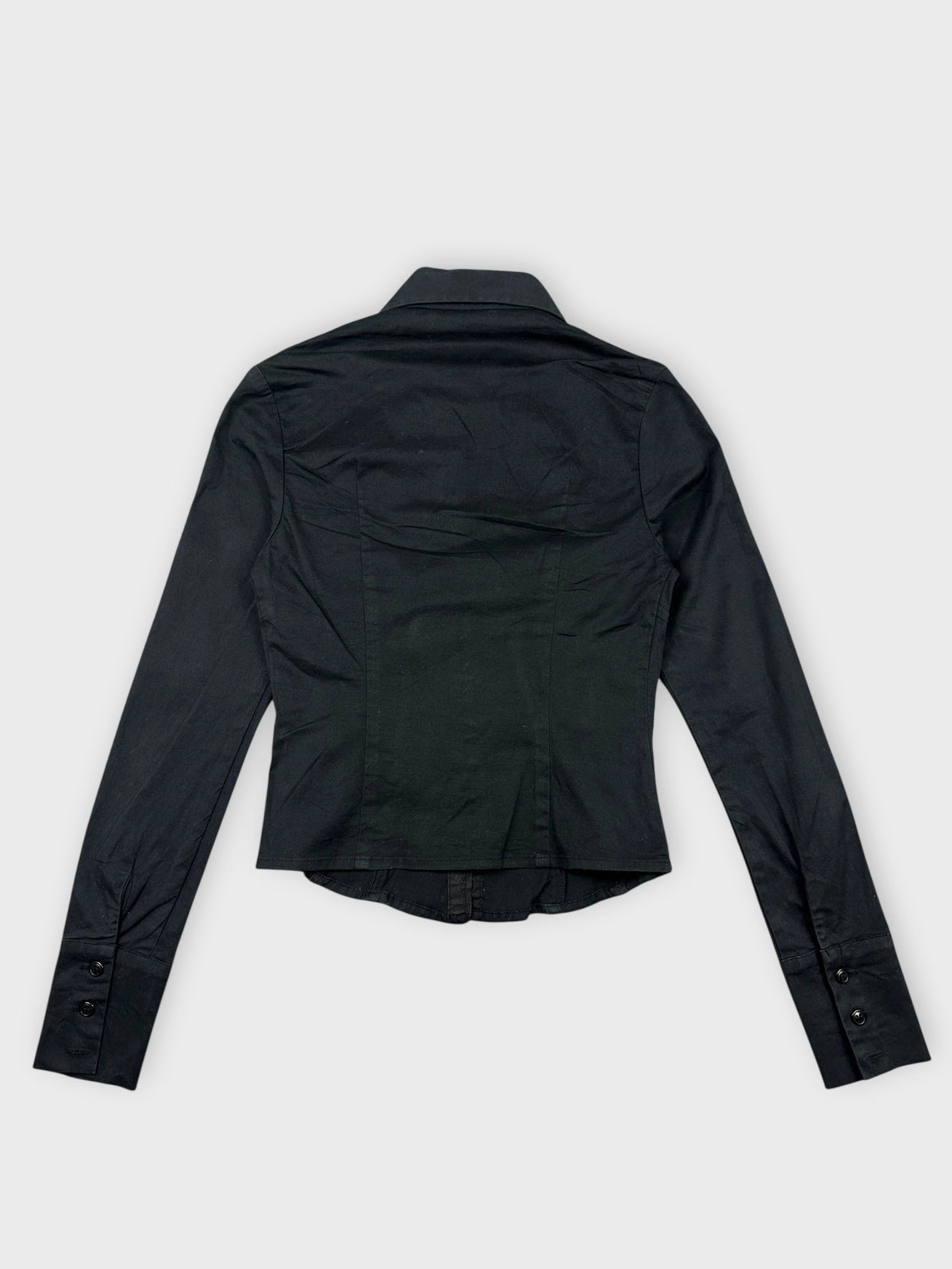 Back view of a black long sleeve cropped button-up shirt with a collar.