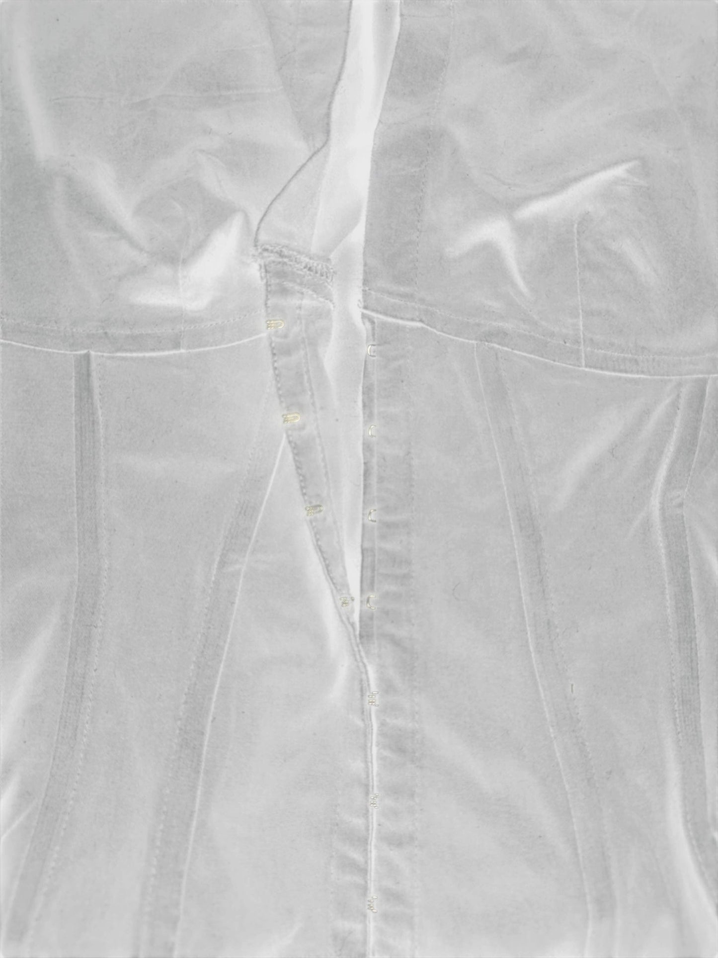 Detail view of a black long sleeve button-up shirt featuring a V-neckline.
