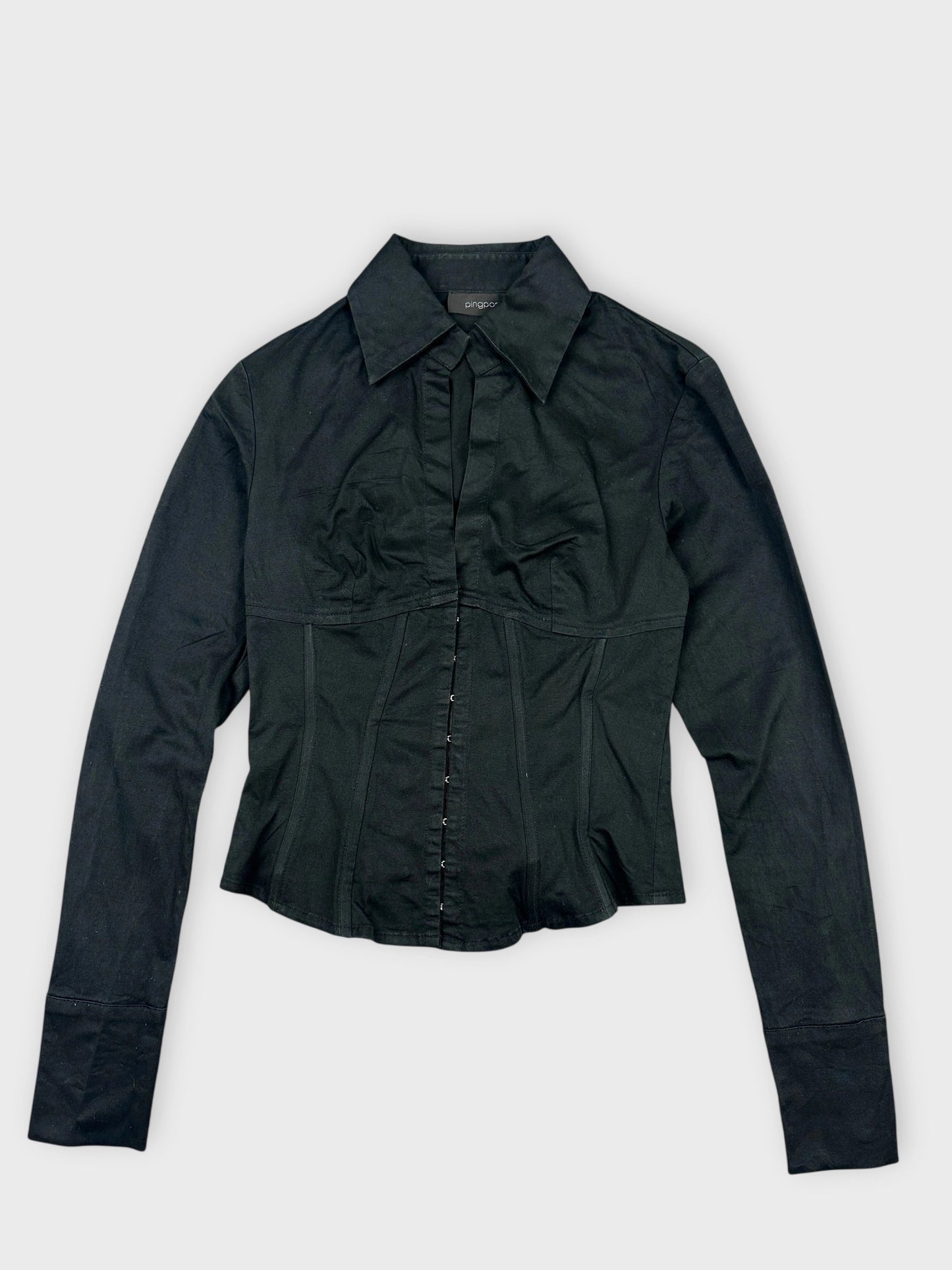 Front view of a black long sleeve button-up shirt with a V-neckline.