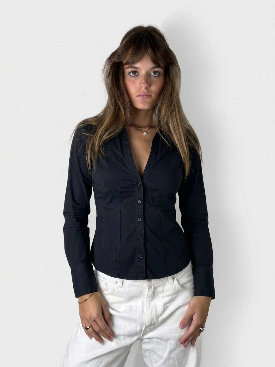 Chic black long sleeve button-up shirt, front view, featuring a button closure.