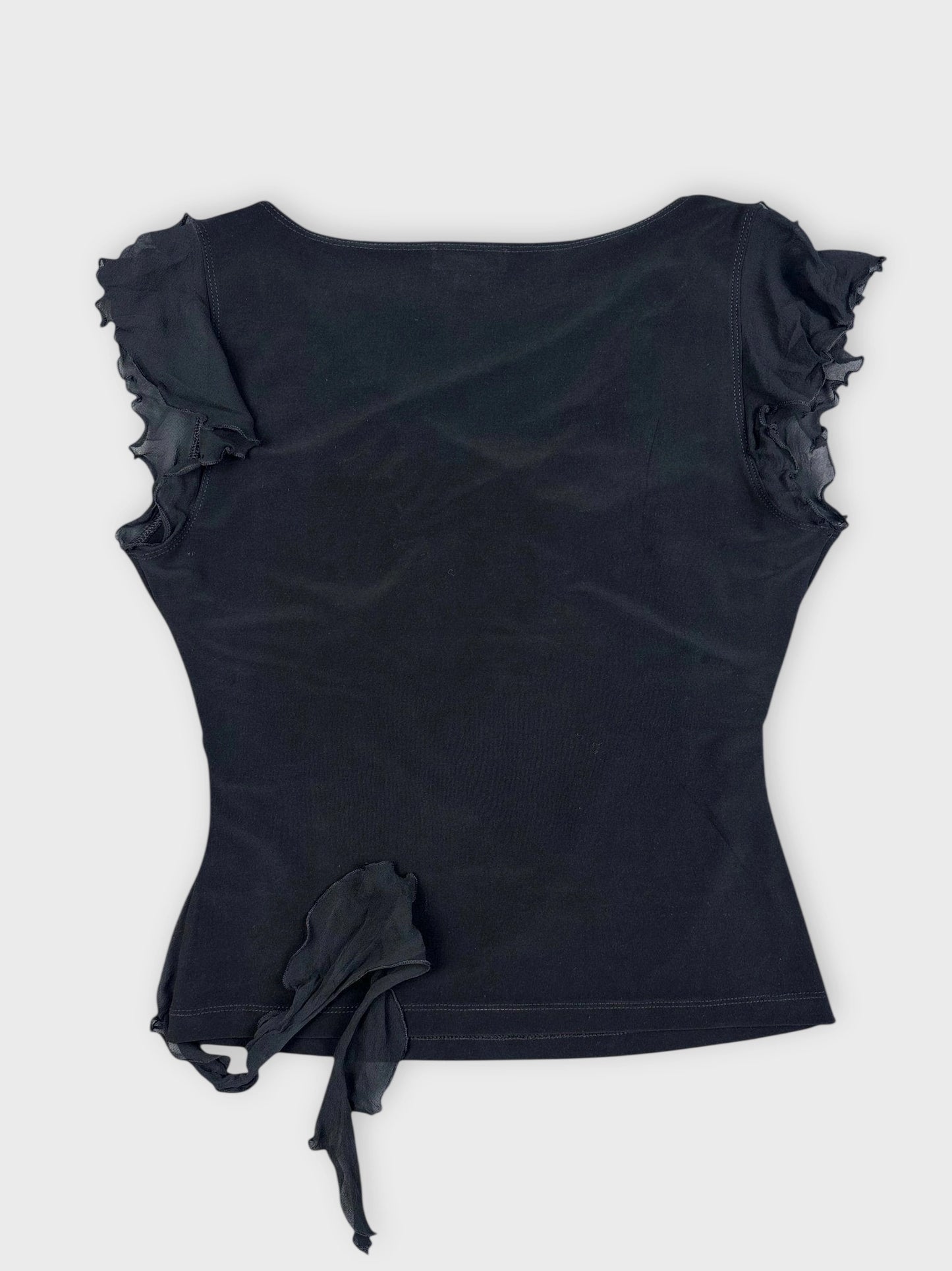 Back view of a black wrap top featuring ruffled sleeves.