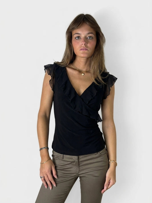 Chic black wrap top with ruffled trim, front view.