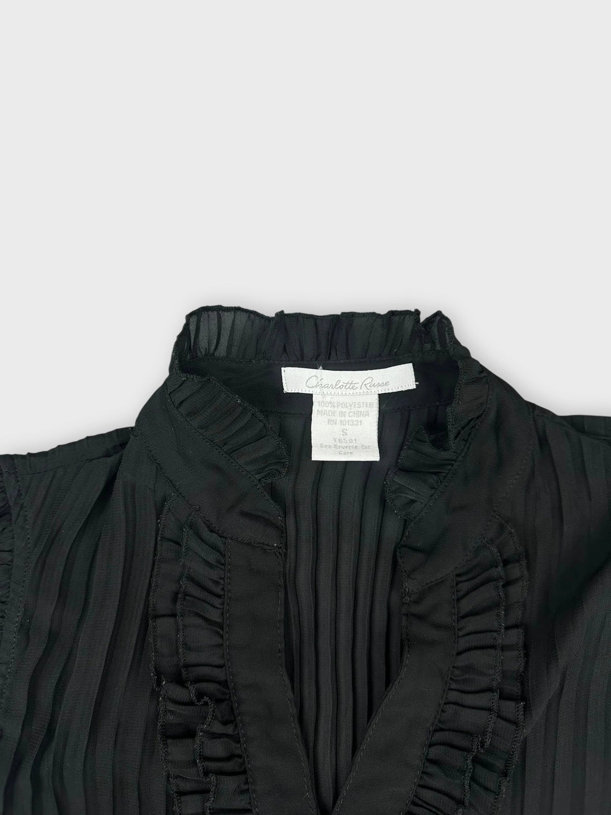 Black button-up top with ruffled collar detail view.