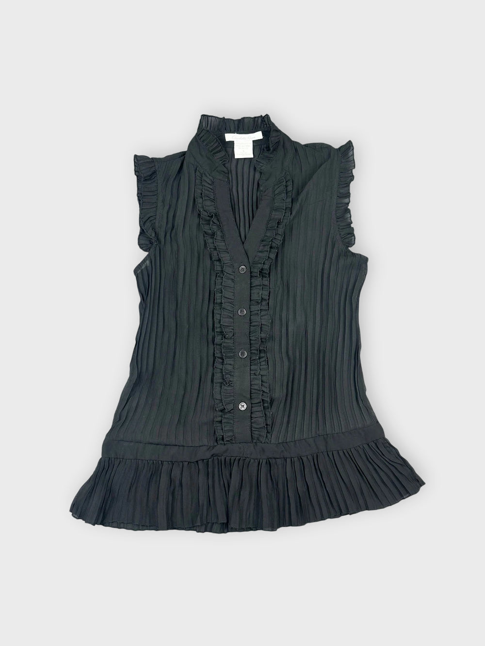 Front view of a black ruffled button-up top with pleated details.