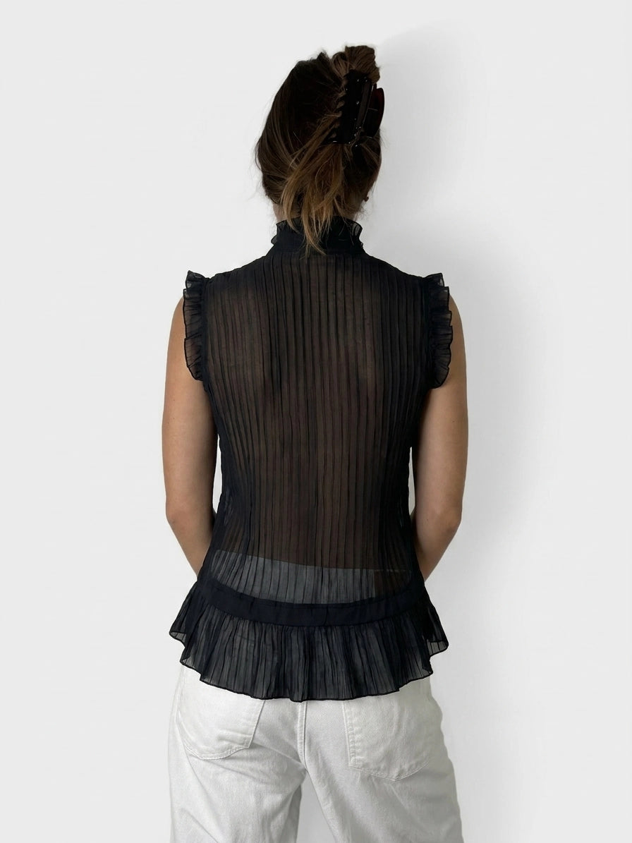 Back view of a black ruffled button-up top with pleated design.