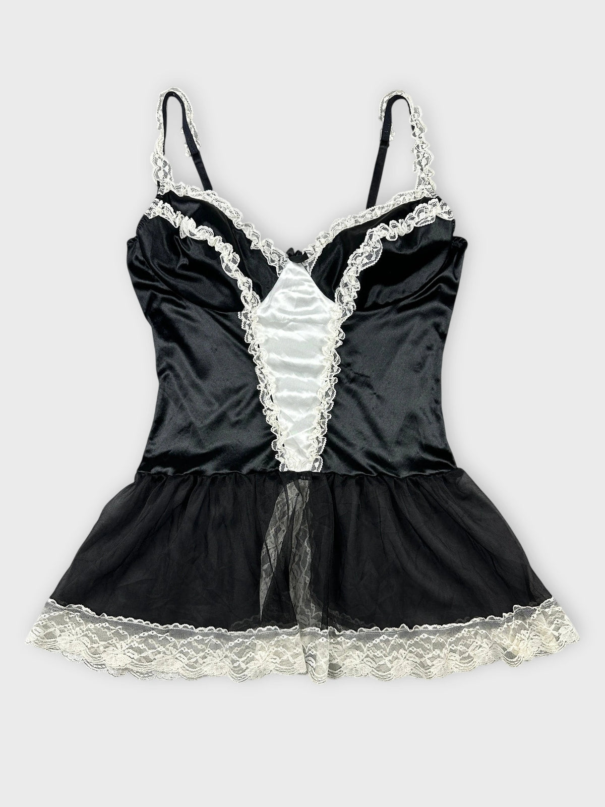 Chic black satin top with lace trim in front view showing ruffled details