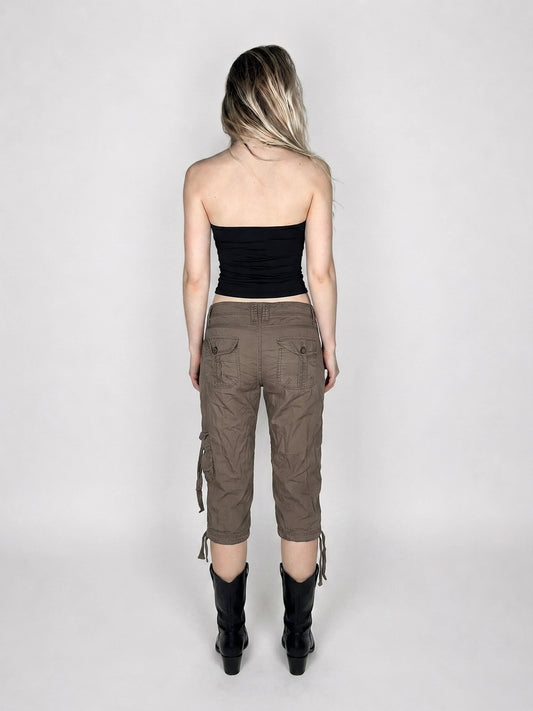 Back view of brown cargo shorts with drawstrings and side pockets.